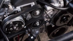 The timing belt, such as this sideways black timing belt on a chrome gray engine is extremely important during long distance trip.