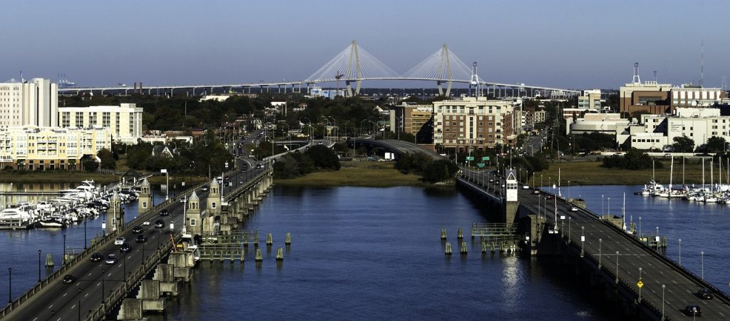 Charleston - one of the best places to retire in South Carolina; cityscape - a river, a bridge, buildings on both banks