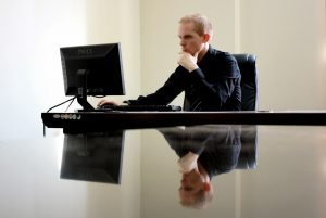 Man sitting at work and looking at his computer.