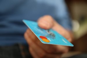 Close up of a hand with a credit card.
