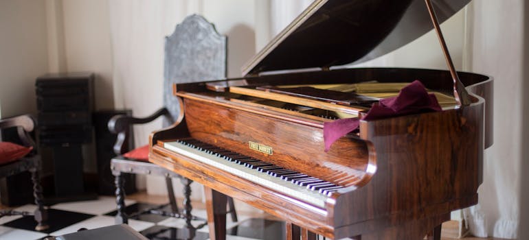 brown grand piano in a room