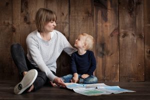 Mother sitting with her child and looking at maps.