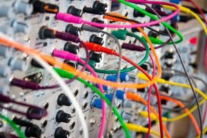 Electrical cables plugged into different sockets in a complicated way