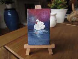 Easel with painting of a swan