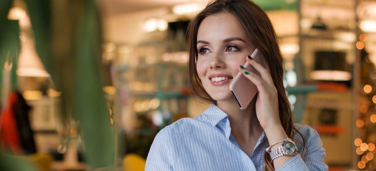 Woman talking via phone with interstate movers Virginia