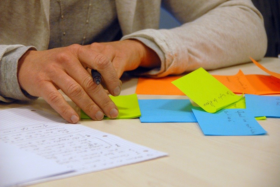 A man sitting in front of post it notes.