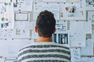 Man looking at hand written plans