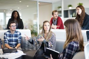 An office meeting. Regular meetings will help avoid employee conflicts when relocating.