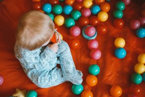 baby playing with balls