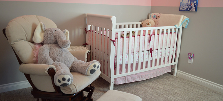 A nursery with toys, chair and baby cot is something cross country movers Minnesota will move for you