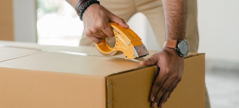 A man taping a box