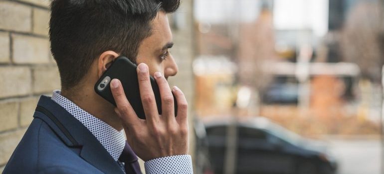 A man in a suit making a phone call.