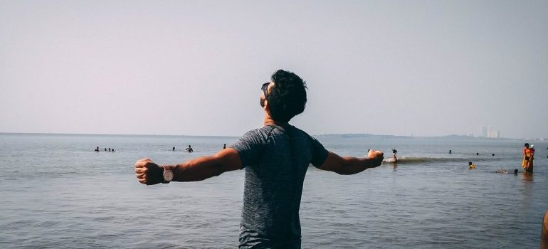 A man standing near the sea after successful move with interstate movers Las Vegas.