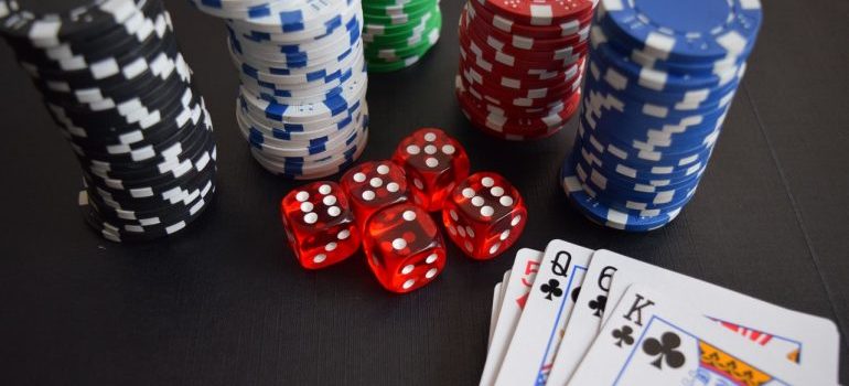 Playing cards, pocker chips, and red die.