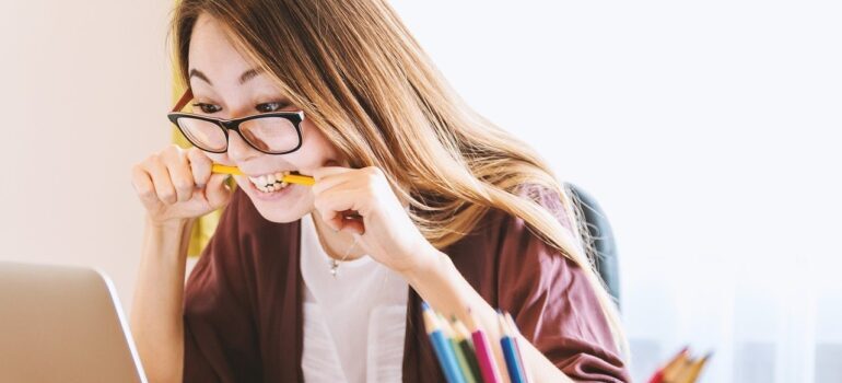 Nervous woman biting a pencil