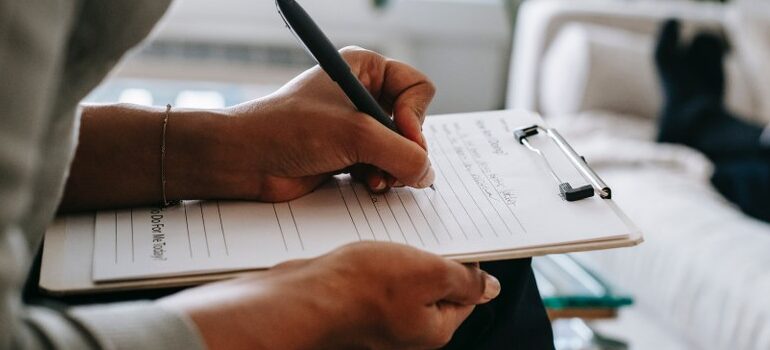 person sitting, writing, making a plan