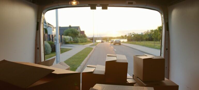 An open van with cardboard boxes, packed by the best cross country movers Jersey City has.