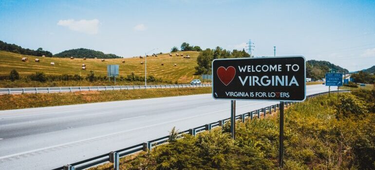 A road with a "Welcome to Virginia" sign nearby.