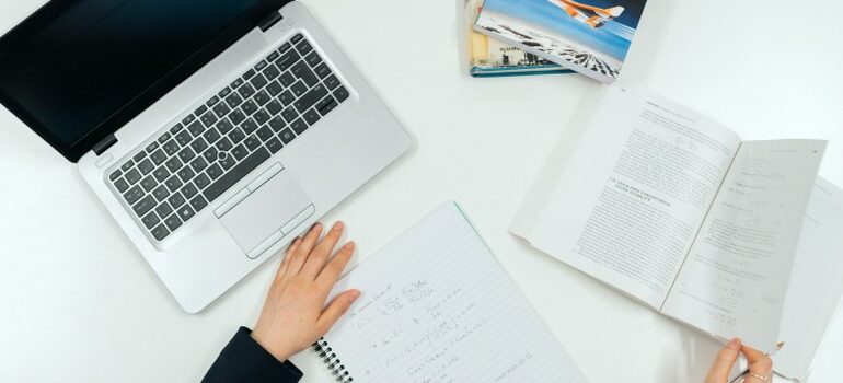 person working in the office, laptop and papers on the table