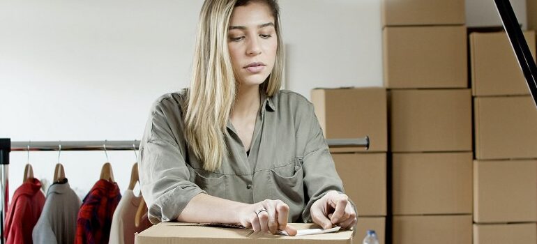 woman packing a cardboard box