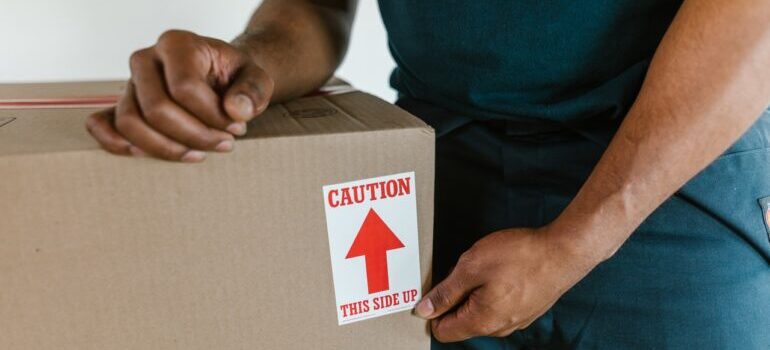 A man carries a moving box