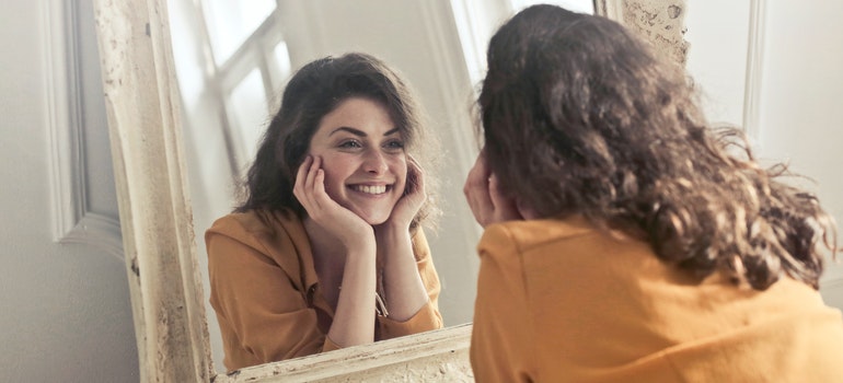 Girl smiling in mirror