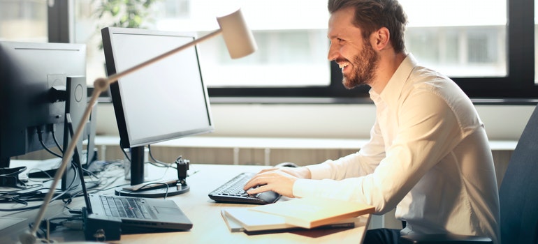 man typing on a computer