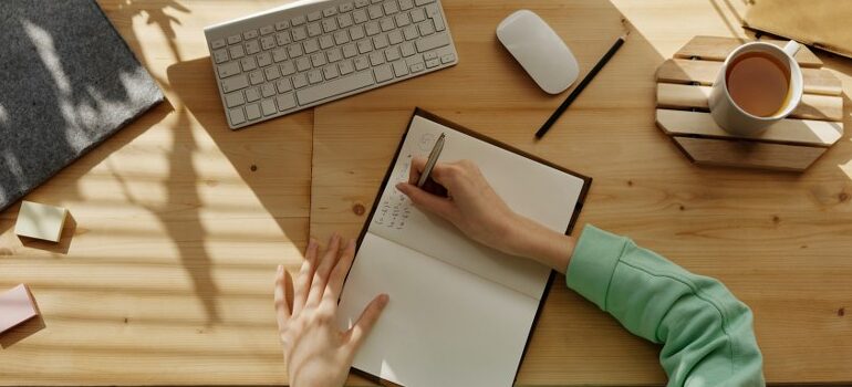 person writing something down in a notebook