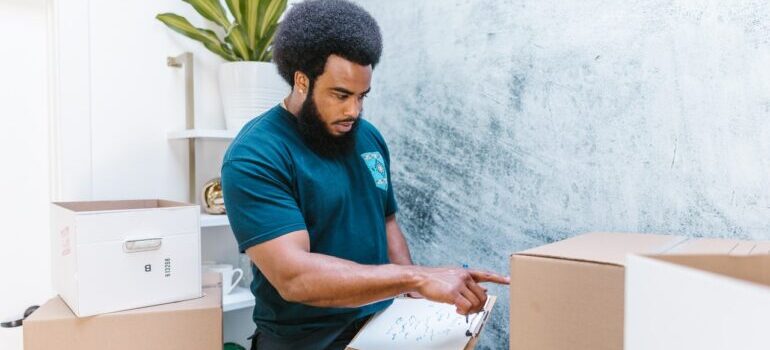 Mover checking on the cardboard boxes for the move.