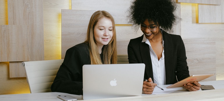 Two girls looking at a laptop