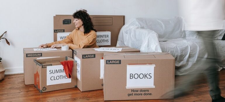 person amid cardboard moving boxes