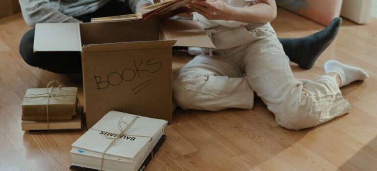 Packing books in a box for moving to Vermont