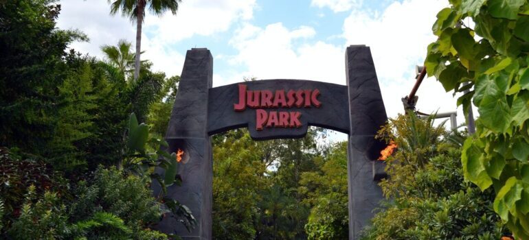 Jurassic Park entrance surrounded with rich greenery.