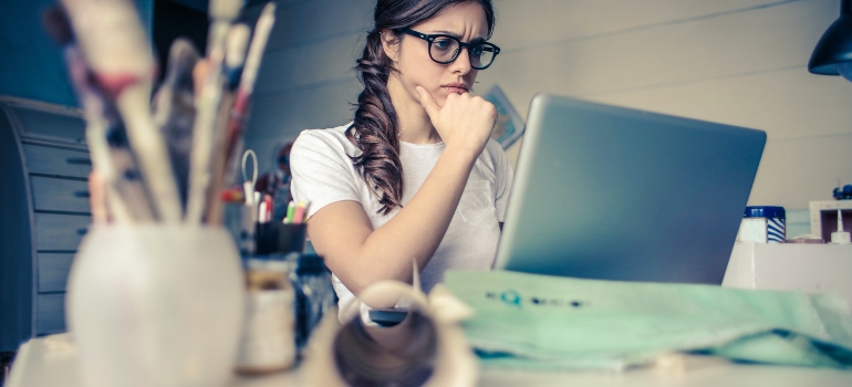Woman researching and thinking if she should rent a house or an apartment