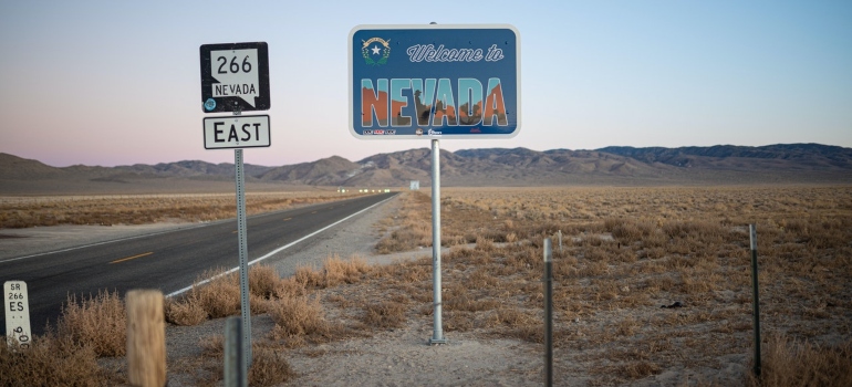 welcome to nevada sign next to the road