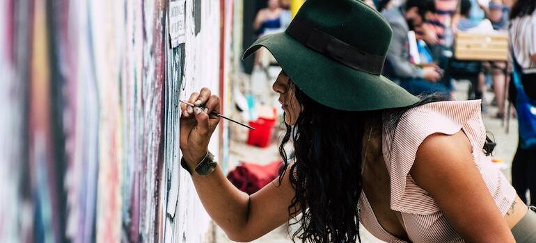 An artist making a mural in one of the US cities for artists