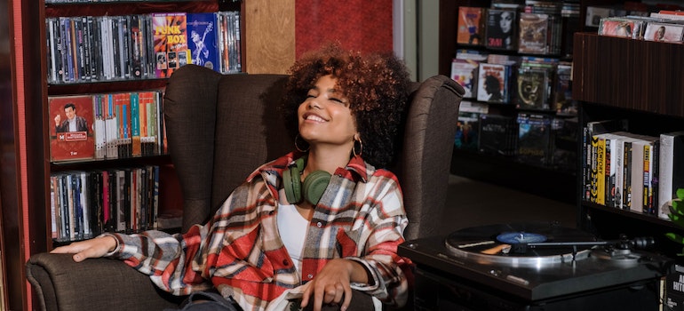 A Woman with Curly Hair Listening to Music.