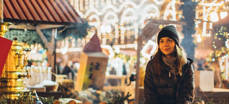 girl posing in front of Christmas market