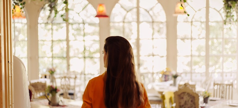 Back view of an woman entering a restaurant