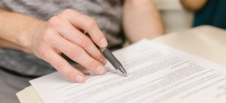 A person Reviewing a lease agreement when Moving out of state with a leased car