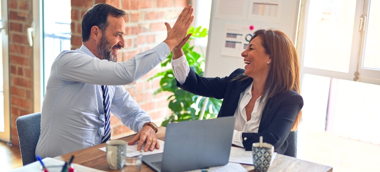 two colleagues high-fiving