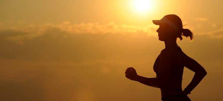 A woman jogging during the sunrise