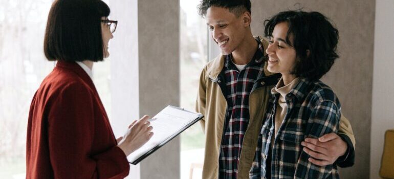 Couple talking to a real estate agent