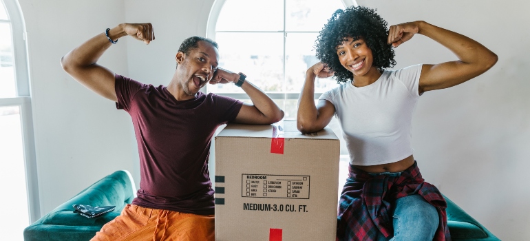 A man and woman with packed moving boxes planning to move
