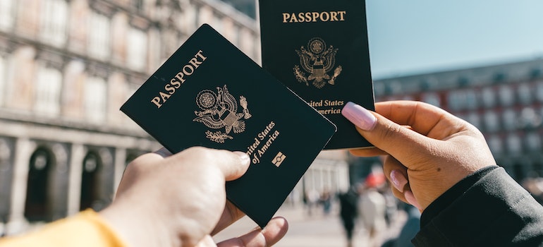 Two people holding passports