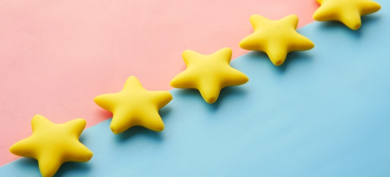 Five gold stars on pink and blue background