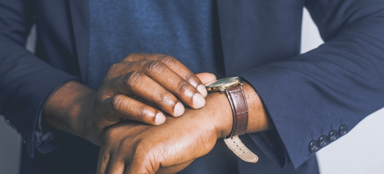 A man looking at a wristwatch