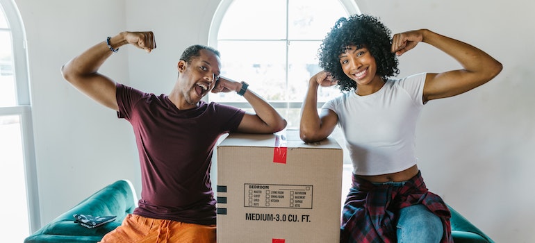 picture of a man and a woman sitting on boxes