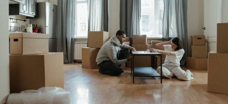 Man and woman working on furniture assembly and installation