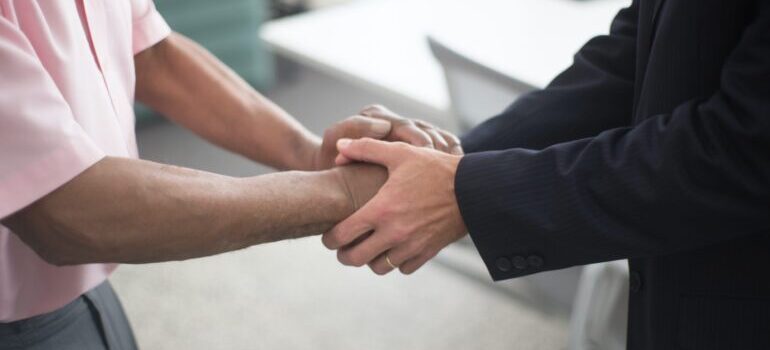 Two people shaking hands after reaching a deal